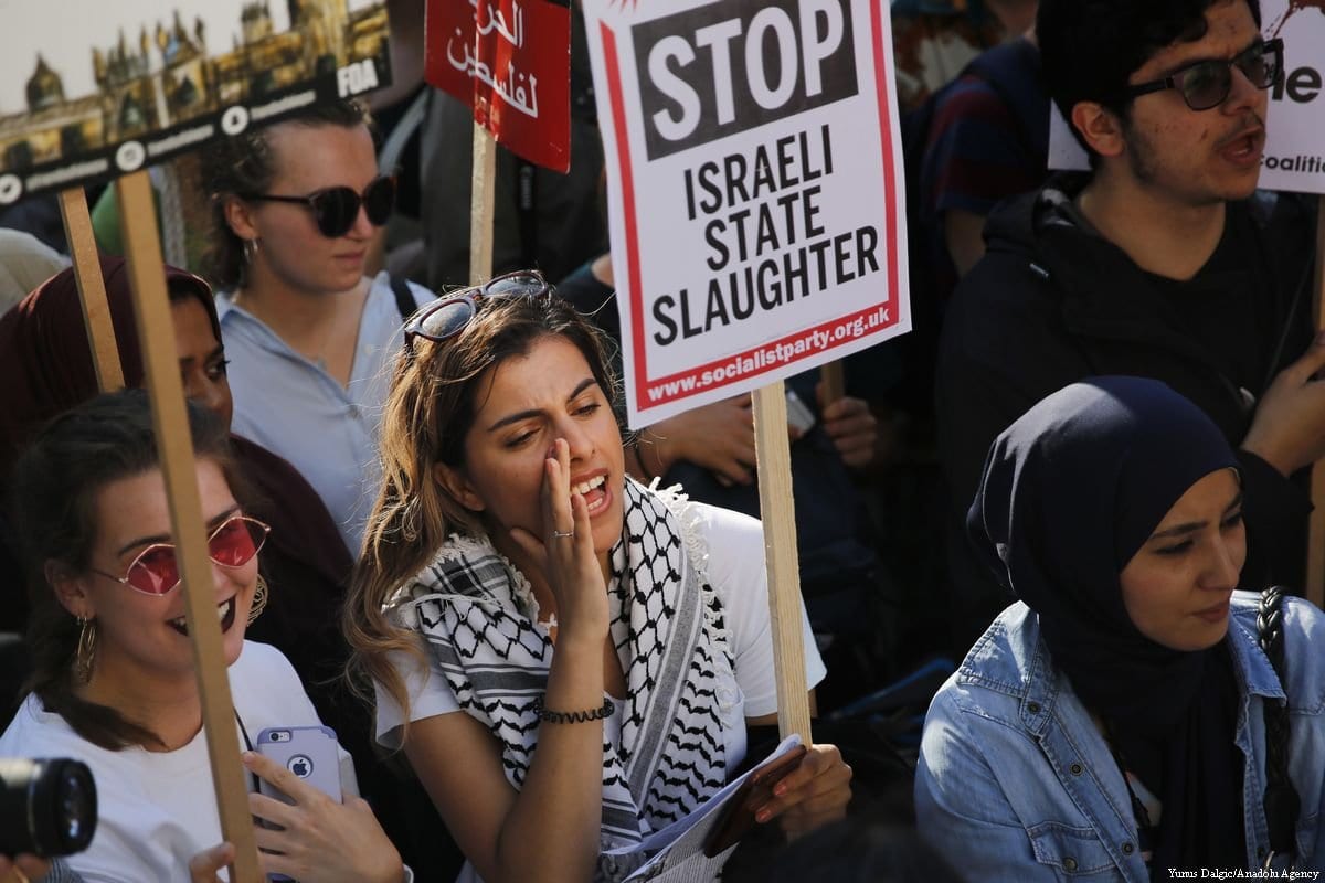 Manifestantes protestam em frente às residências oficiais do governo britânico, na rua Downing, com cartazes e bandeiras, contra os abusos de Israel aos palestinos, em Londres, Reino Unido, 15 de maio de 2018 [Yunus Dalgic/Agência Anadolu]