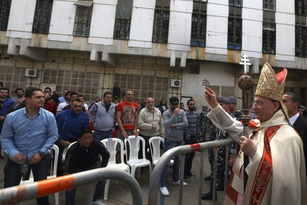 Bechara Boutros Al-Rai, Patriarca da Antióquia e Levante, concede sua bênção a prisioneiros e guardas durante missa de Quinta-feira Santa, na prisão Roumieh, a norte de Beirute, capital do Líbano, em 24 de março de 2016 [Patrick Baz/AFP/Getty Images]