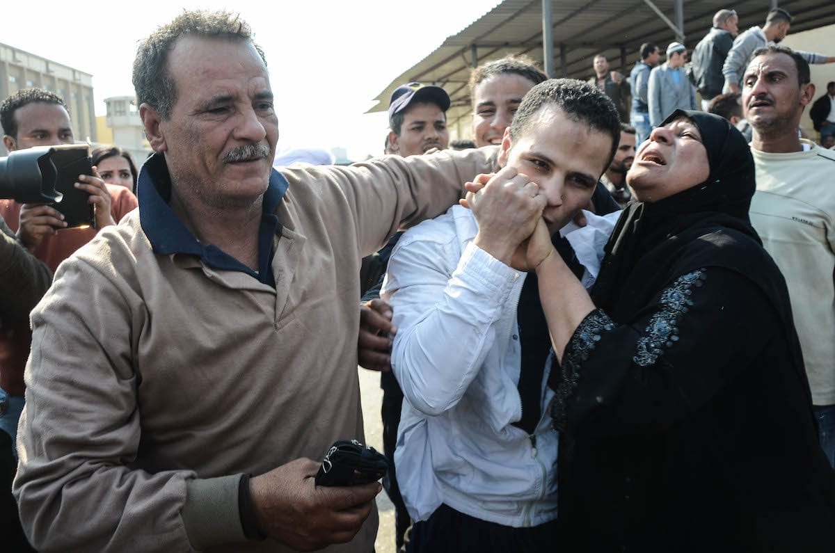 Um egípcio abraça seus pais após sair da prisão no Cairo em 14 de março de 2017, junto com 202 outros prisioneiros que receberam um perdão presidencial. [ALY FAHIM / AFP via Getty Images]