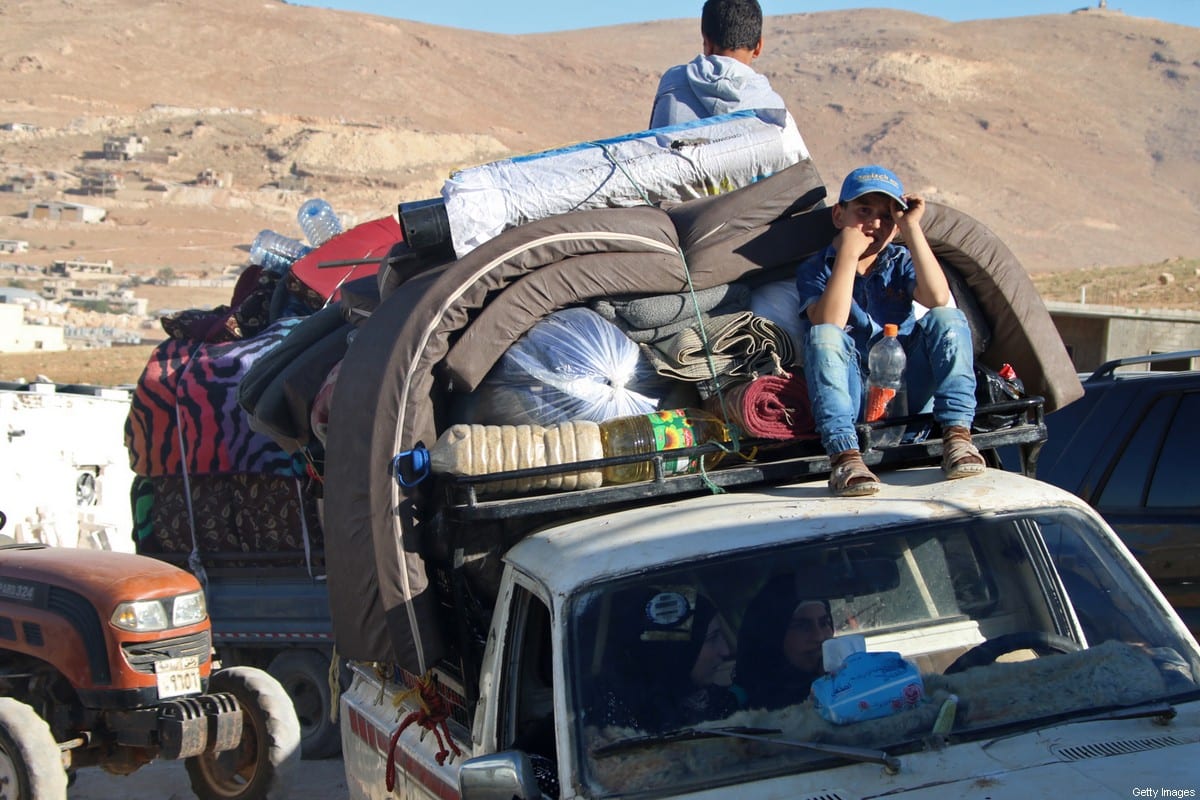 Sírios se preparam para deixar seu campo de refugiados no Líbano em 7 de julho de 2018 [AFP / Getty Images]