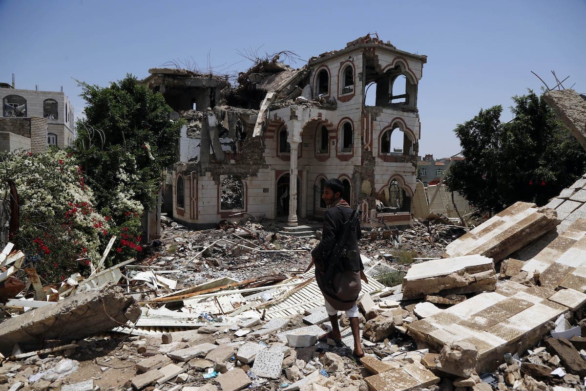 Um homem caminha sobre os escombros de uma casa atingida por ataques aéreos perpetrados por aviões de guerra da coalizão liderada pelos sauditas, em 28 de julho de 2019, em Sana'a, Iêmen [Mohammed Hamoud/Getty Images]
