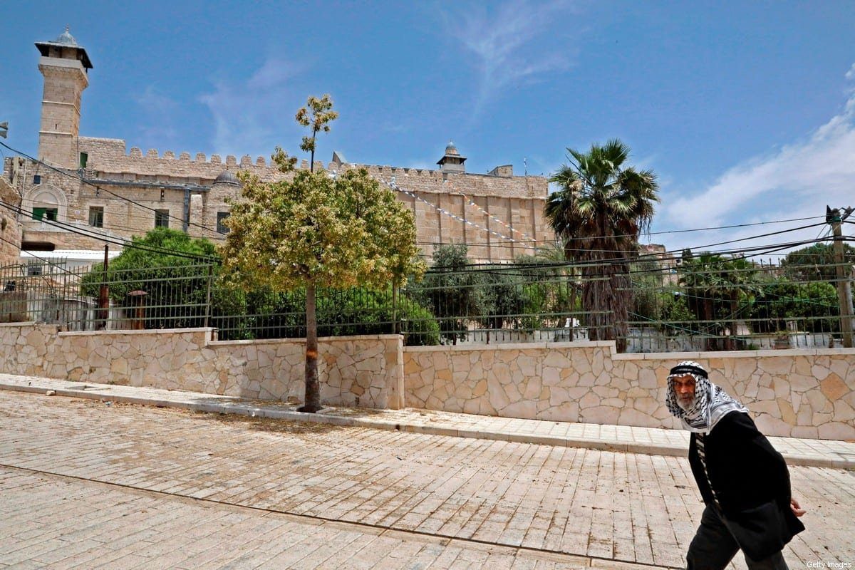 Palestino caminha em frente à Mesquita Abraâmica (Túmulo dos Patriarcas), em Hebron, Cisjordânia ocupada, 15 de maio de 2020 [Hazem Bader/AFP/Getty Images]
