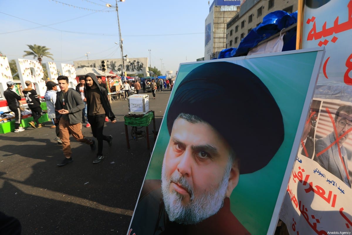 Cartaz do líder do movimento sadrista Muqtada Al-Sadr é visto enquanto manifestantes iraquianos se reúnem na Praça Tahrir em Bagdá, Iraque, em 3 de janeiro de 2020 [Murtadha Sudani/Agência Anadolu]