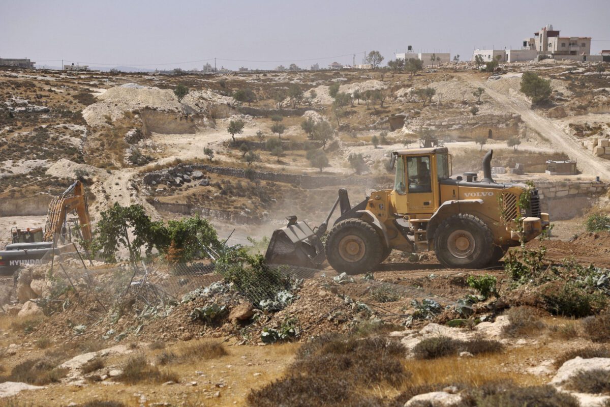 Trator israelense destrói terras agrárias palestinas nos arredores de Hebron (Al-Khalil), Cisjordânia ocupada, 25 de agosto de 2021 [HAZEM BADER/AFP via Getty Images]