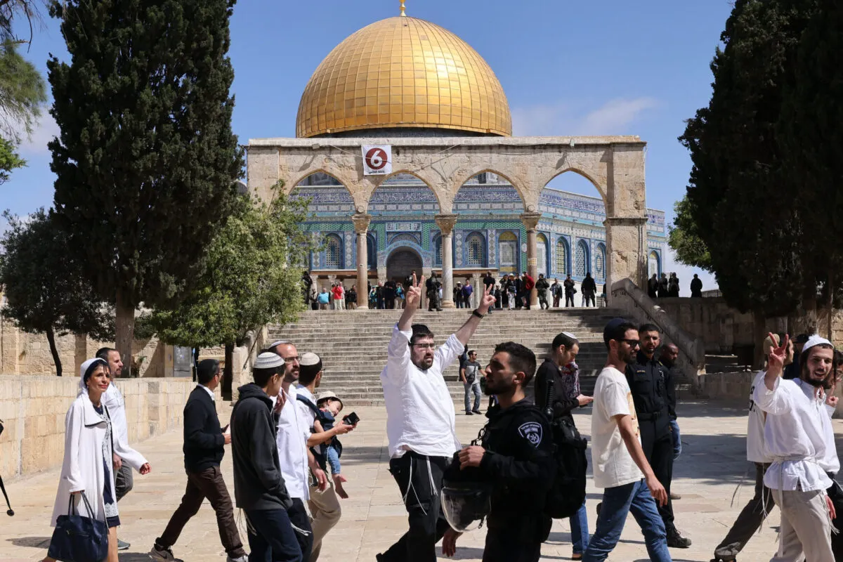 Palestinos atiram pedras em resposta ao ataque das forças israelenses após uma oração matinal no Masjid al-Aqsa em Jerusalém Oriental em 22 de abril de 2022. A polícia israelense invadiu o complexo da Mesquita Al-Aqsa em Jerusalém Oriental usando balas revestidas de borracha e bombas de som na sexta-feira. [Mostafa Alkharouf - Agência Anadolu]
