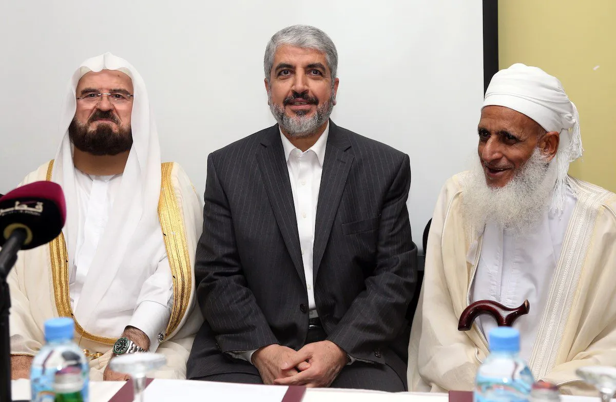 Esquerda para direita: Ali Moheiddin al-Qaradaghi, secretário-geral da União Internacional de Estudiosos Muçulmanos; Khaled Meshaal, chefe político do movimento Hamas; e Ahmed bin Hamad al-Khalili, grão-mufti do Sultanato de Omã, durante encontro na cidade de Doha, Catar, 21 de setembro de 2014 [Faisal al-Tamimi/AFP via Getty Images]
