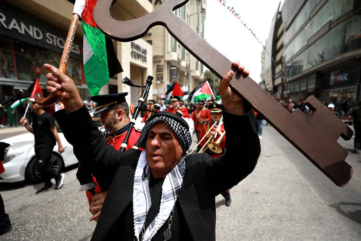 Pessoas participam de manifestação com bandeiras e faixas palestinas no 74º aniversário da Nakba, em Ramallah, Cisjordânia, em 15 de maio de 2022. [Issam Rimawi - Agência Anadolu] 
