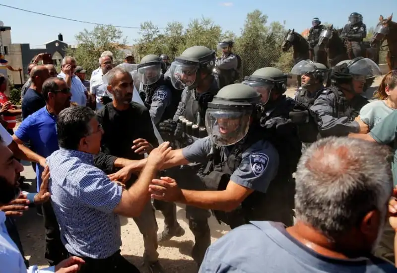Policiais da ocupação israelense reprimem palestinos durante protesto de colonos de direita perto da residência de Nashat Melhem, acusado de matar três pessoas, na aldeia árabe de Arara, no norte do território considerado Israel, em 19 de setembro de 2016 [Ammar Awa/Reuters]
