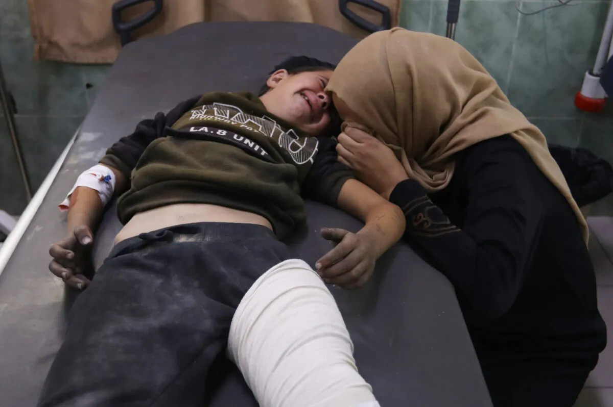 Criança palestina ferida pelos bombardeios israelenses chora com sua mãe no Hospital al-Najjar, em Rafah, no sul de Gaza, em 30 de outubro de 2023 [Abed Rahim Khatib/Agência Anadolu]
