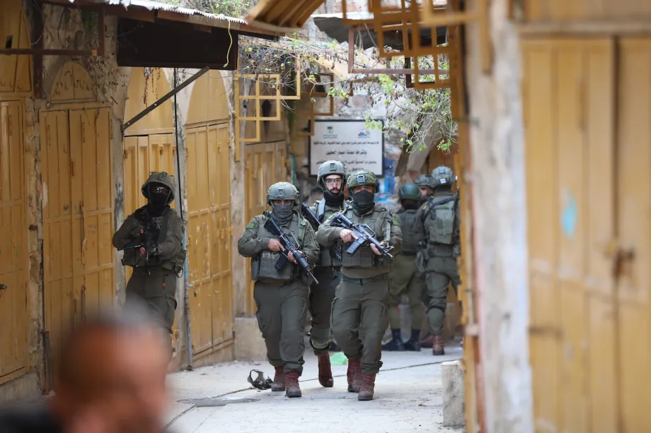 Soldados israelenses escoltam colonos ilegais durante invasão à Cidade Velha de Hebron, na Cisjordânia ocupada, em 24 de janeiro de 2026 [Wisam Hashlamoun/Agência Anadolu]